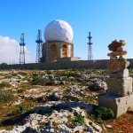 The radar tower at Dingli Cliffs, with inukshuk pebble tower in foreground
